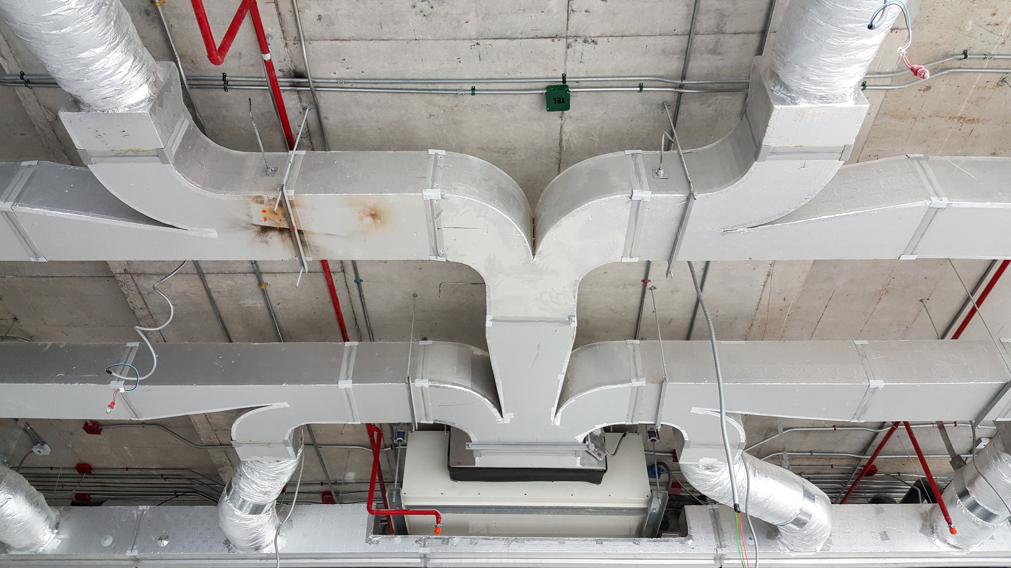 Close up air condition and hvac system installation under concrete ceiling before interior finishing.